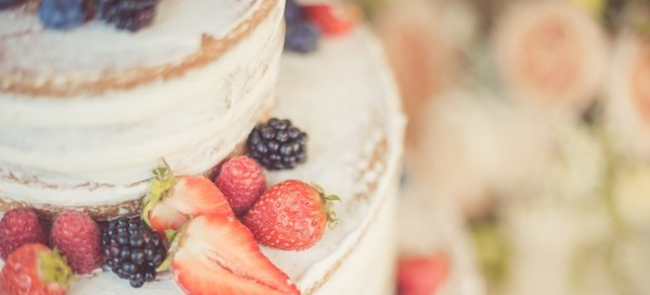 This naked berry cake is both beautifully decorated and delicious within 2 tiers. Made with light, fluffy vanilla cake and minimally frosted with vanilla buttercream. It is decorated with fresh berries on top for a pop of color and flavor.