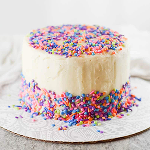 This cake is created with confetti batter and filled with confetti buttercream. It is topped with sprinkles all around to be perfect for any birthday celebration. This cake is filled with everything strawberry! It is a double-layer cake decorated with strawberries and whipped cream.