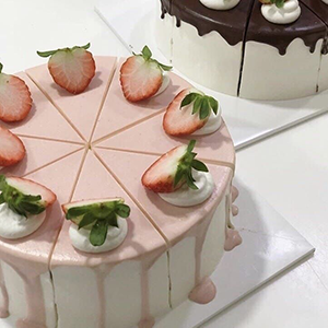 This cake is filled with everything strawberry and cream. It is a double-layer cake decorated with strawberries and whipped cream.