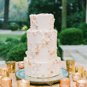 This cake is perfect for your formal occasions. It features the cake of your choice and is topped with white edible flowers that are carefully placed.