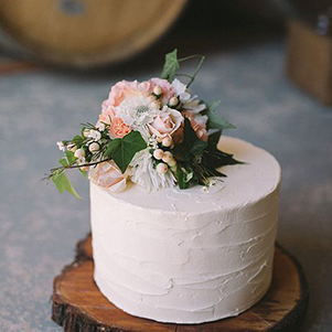 This is one of our basic cakes that can be filled with any flavor cake and frosting. It features a small arrangement of flowers on top. This cake is perfect for any small gathering.